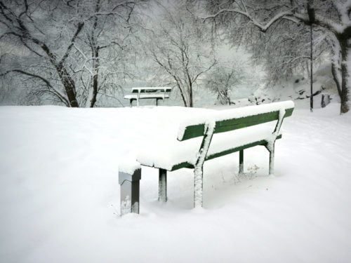 green bench with snow at park with PEDOC Power outdoor pedestal